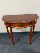 A reproduction mahogany shaped hall table on reeded legs