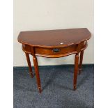 A reproduction mahogany shaped hall table on reeded legs