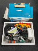 A boxed shower force pump together with a further box of hose pipe attachments,