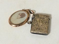 A 9ct gold rimmed locket together with a silver vesta