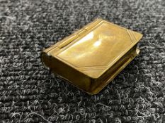 A brass stamp and match holder in the form of a book