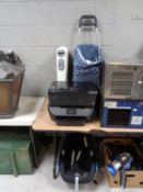 Two HP printers together with a shopping trolley containing metal bin and fan,