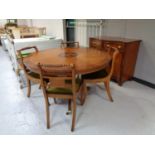 A six piece mahogany and cherry wood dining room suite - circular table,