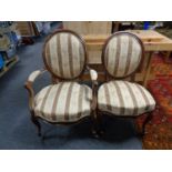 An antique walnut scroll armchair together with matching dining chair in Regency stripe fabric