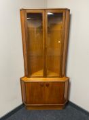 A Tunridge mid century teak corner display cabinet with double cupboard beneath