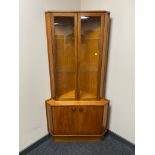 A Tunridge mid century teak corner display cabinet with double cupboard beneath