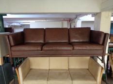 A mid century Danish brown leather three seater settee