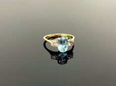 An 18ct gold two stone diamond and aquamarine ring, size M/N, approximately 0.4ct diamonds.