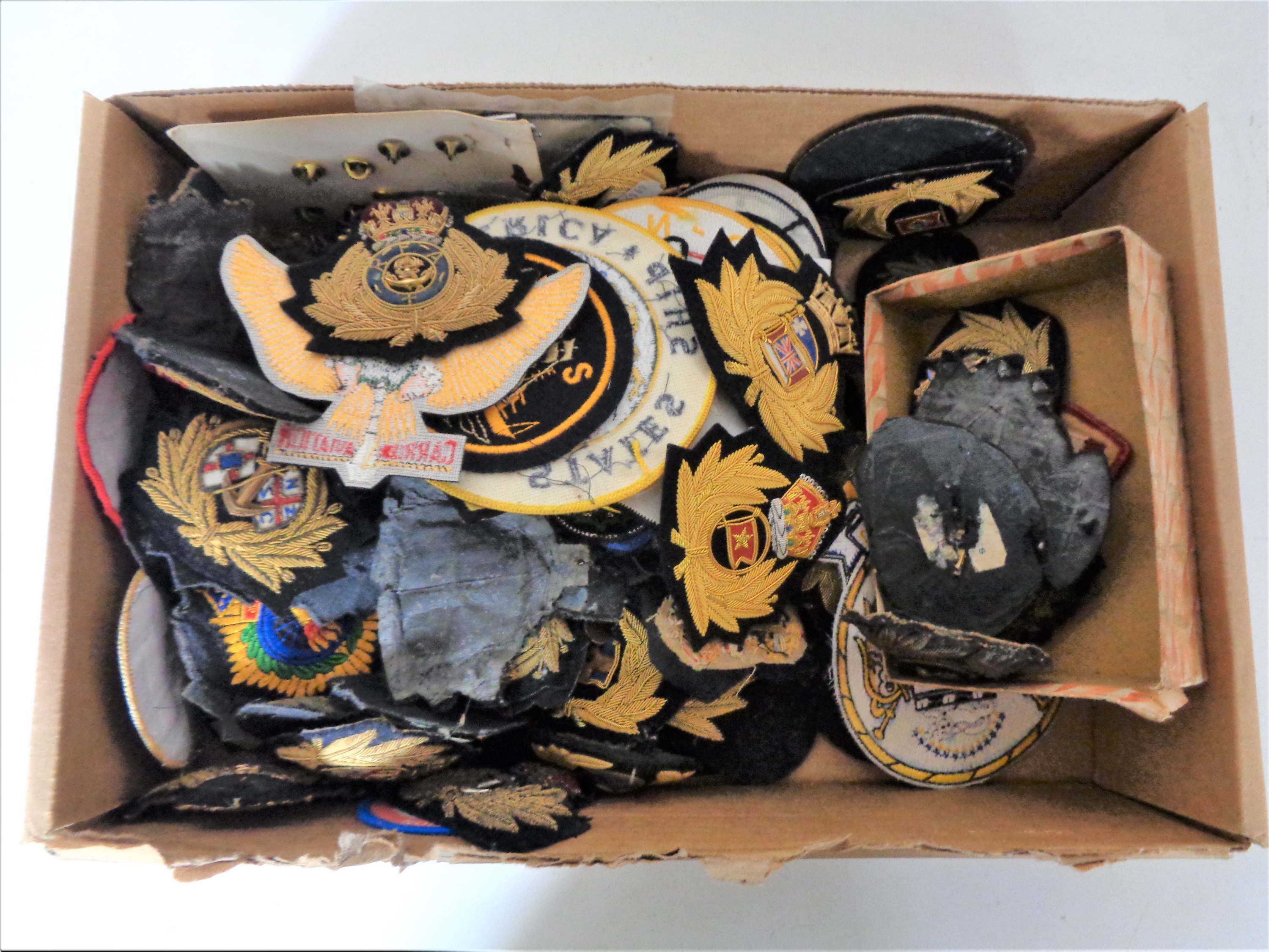 A box of large quantity of military sew on patches and enamelled badges