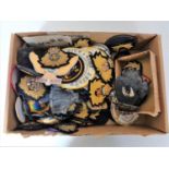 A box of large quantity of military sew on patches and enamelled badges