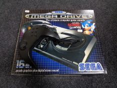 A boxed Sega Megadrive console together with additional Maxfire joy pad