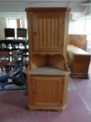 A pine double corner cabinet