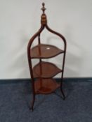 An Edwardian inlaid mahogany three tier cake stand