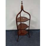 An Edwardian inlaid mahogany three tier cake stand