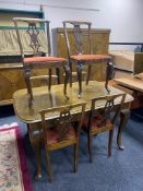 A mid century reproduction dining table and six chairs