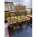 A mid century reproduction dining table and six chairs