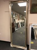 A silver framed floor standing mirror