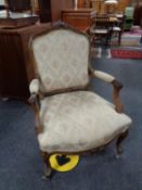 A walnut framed French armchair upholstered in floral fabric