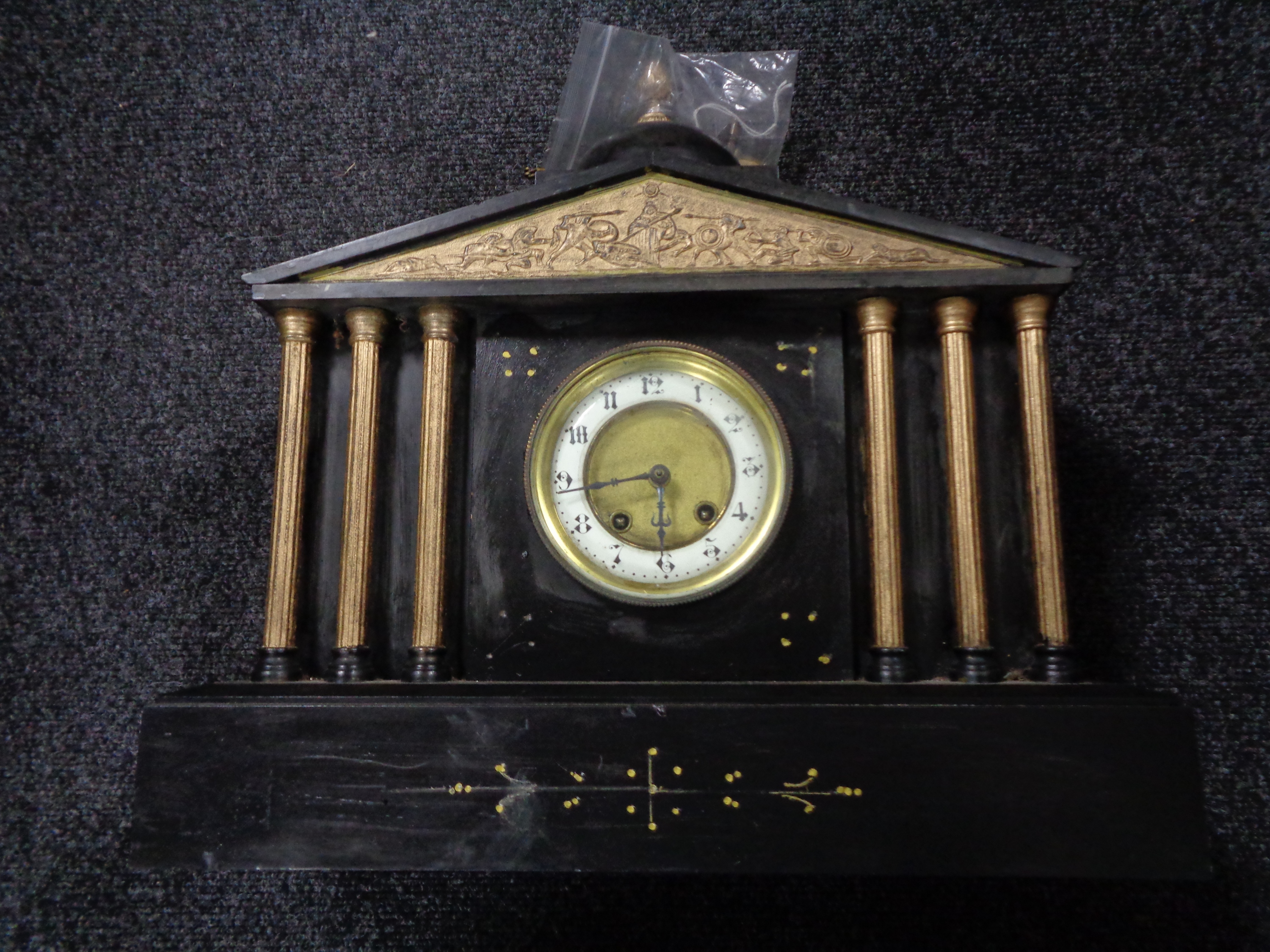 A Victorian slate gilt highlighted mantel clock with pendulum and key