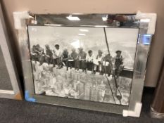A mirrored framed picture of workmen