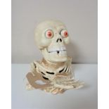 A cast iron skeleton money box