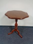 An antique mahogany shaped topped pedestal table