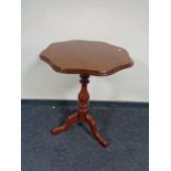 An antique mahogany shaped topped pedestal table