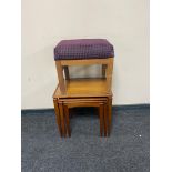 A nest of three mid century teak tables together with an Myer footstool