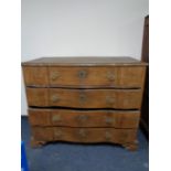 A nineteenth century oak serpentine fronted chest on bracket feet