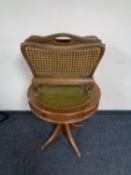 An oak begere magazine rack and leather topped drum table