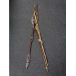 A tribal spear together with a carved two piece snooker cue,