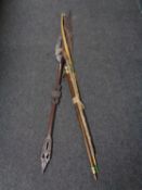 A tribal spear together with a carved two piece snooker cue,