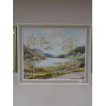 A framed oil on board - lake scene with mountains beyond by Janet Roberts