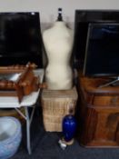 A mannequin torso together with a set of two graduated wicker baskets,