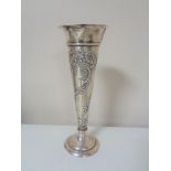 A slender silver spill vase