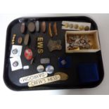 A tray of assorted enamelled badges, naval badges and buttons,