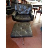 A mid century Danish black buttoned leather armchair with similar stool