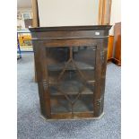 A Georgian oak astral glazed corner cabinet