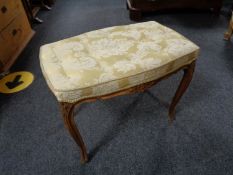 A French walnut dressing table stool on cabriole legs upholstered in classical fabric