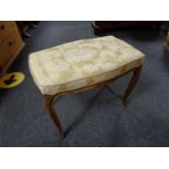 A French walnut dressing table stool on cabriole legs upholstered in classical fabric