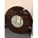 A two tone all glass circular mirror,