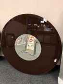 A two tone all glass circular mirror,
