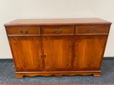 A reproduction yewwood sideboard