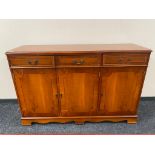 A reproduction yewwood sideboard