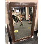 A brown leather effect contemporary mirror