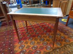 An antique mahogany writing table with green leather inset panel