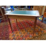 An antique mahogany writing table with green leather inset panel