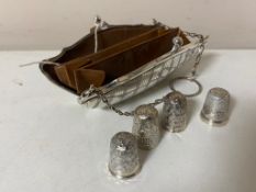 A silver purse together with four silver thimbles