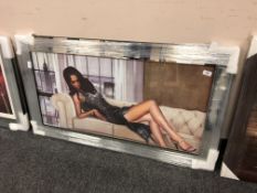 A mirrored framed picture depicting a lady
