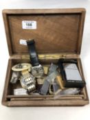 A trinket box containing Seiko and other watches, lighters including Dunhill and Zippo,